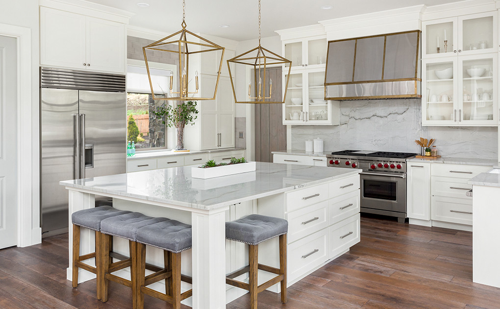 Luxury kitchen with white cabinets and gold accents